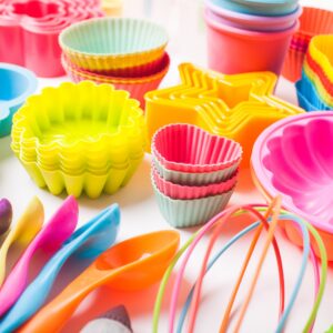 Rainbow silicone confectionery utensils on a white background