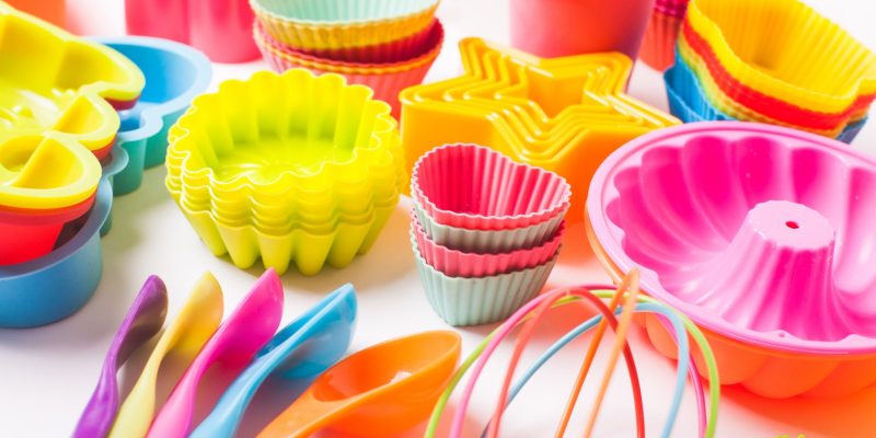 Rainbow silicone confectionery utensils on a white background