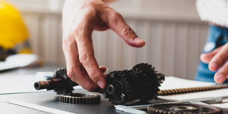 Close-up of an engineer at his desk to design the gear inside the engine.